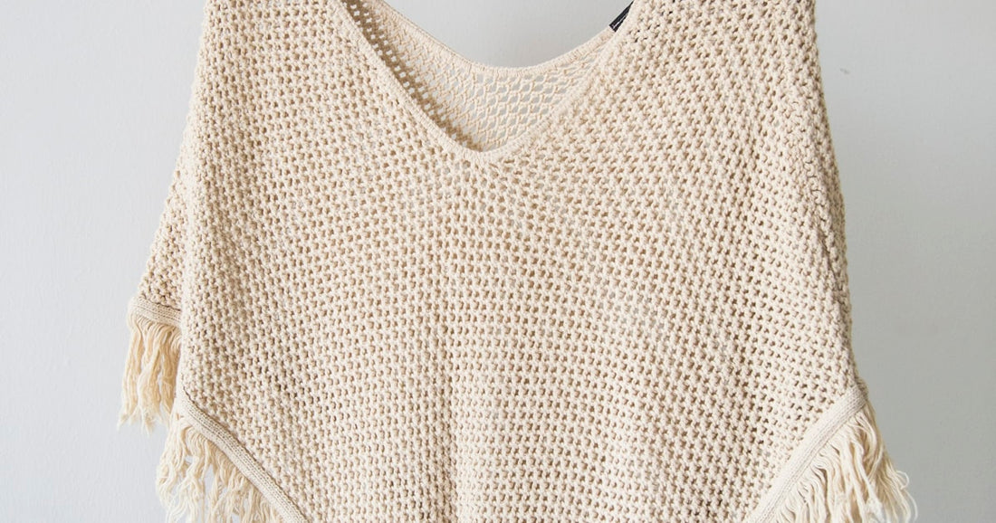 Woman building a capsule wardrobe with curated women's clothing pieces in neutral tones