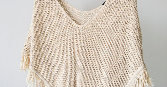 Woman building a capsule wardrobe with curated women's clothing pieces in neutral tones
